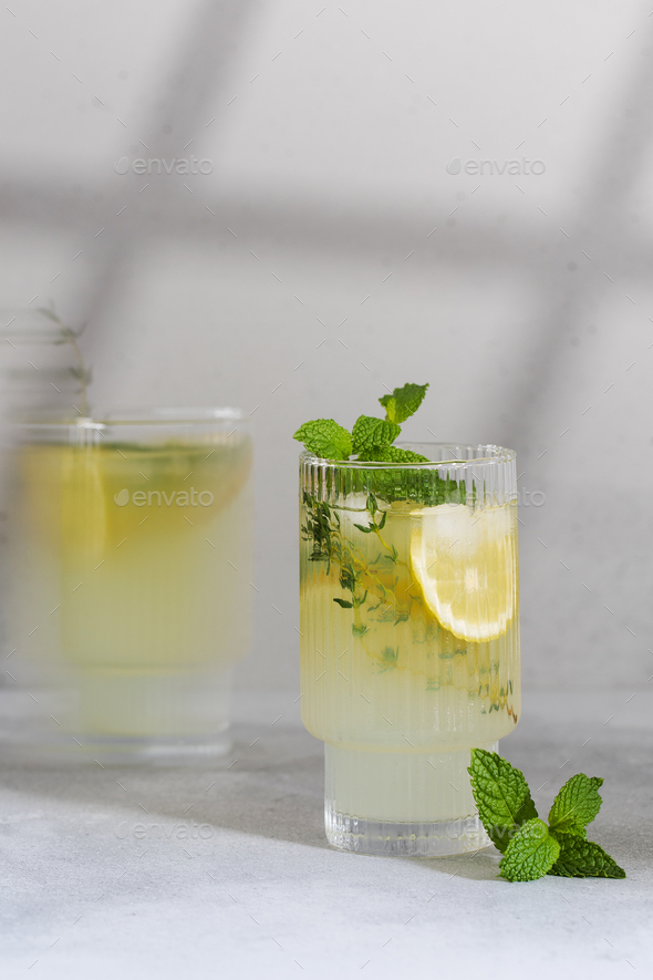 Lemonade with fresh lemon slices in a glass in the photo with a cinematic effect.  - Stock Photo - Images