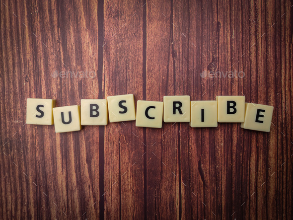 Toys word arranged on a wooden background with the arrangement of the word SUBSCRIBE - Stock Photo - Images