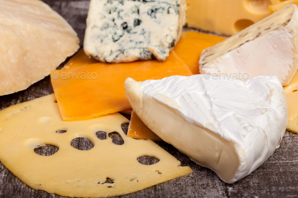 Differet type of cheese on wooden background - Stock Photo - Images