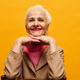 Smiling senior woman in smart casualwear sitting in front of camera - PhotoDune Item for Sale