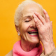 Laughing senior woman with white hair covering half of face with hand - PhotoDune Item for Sale