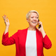 Mature blond woman in red blazer and white blouse speaking on mobile phone - PhotoDune Item for Sale