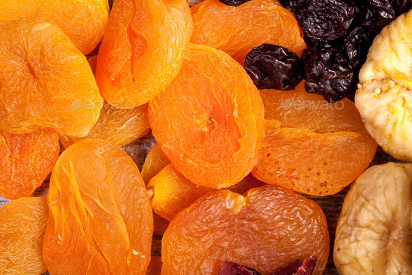 Close up image of dried fruits on wooden background - Stock Photo - Images