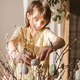A teenage girl decorates the branches of the house with Easter eggs. Easter decoration  - PhotoDune Item for Sale