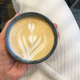 Female hand holding latte at the cafe - PhotoDune Item for Sale