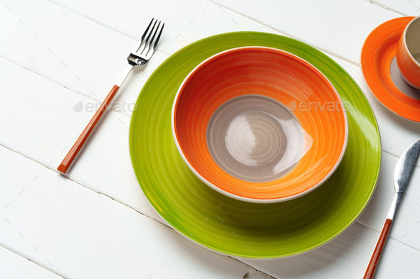 Top view of color ceramic plate on wooden background - Stock Photo - Images