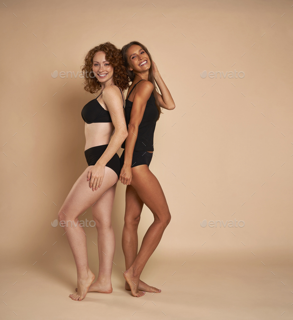 Premium Photo  Two slim young women in sexy underwear standing