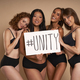 Group of women in underwear looking at camera and holding banner - PhotoDune Item for Sale