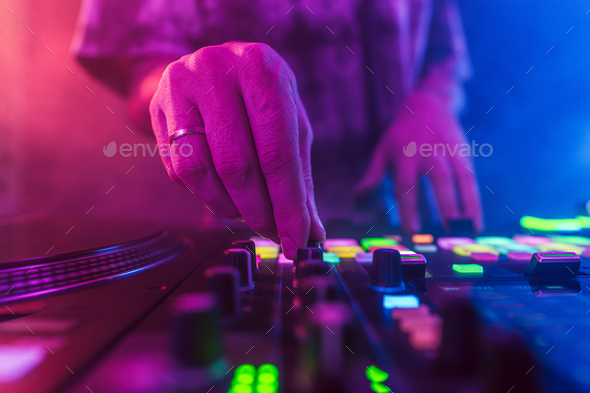 Close up of DJ hands on dj console mixer during concert in the club - Stock Photo - Images