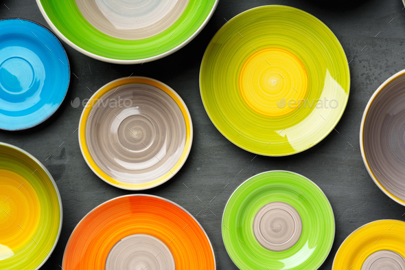 Color ceramic plates on gray background top view - Stock Photo - Images