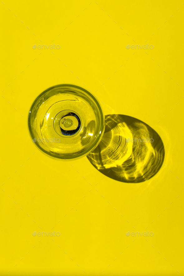 top view of empty glass with reflextion on yellow background - Stock Photo - Images