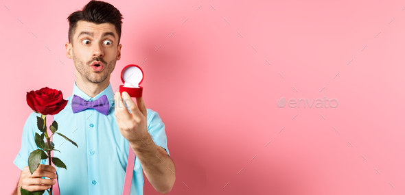 Valentines day. Romantic funny guy going to make wedding proposal, asking to marry him, holding red