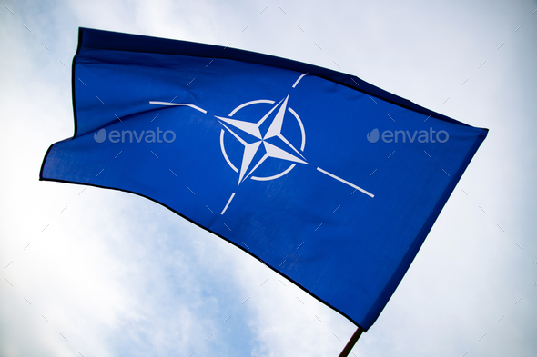 NATO flag.North Atlantic Treaty Organization flag waving. - Stock Photo - Images