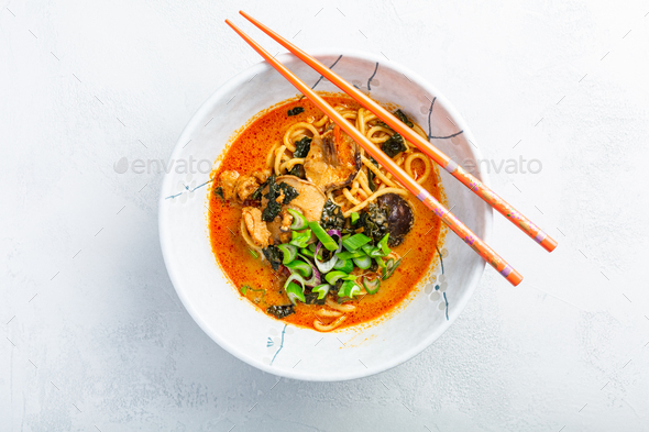 Thai red curry noodle soup with shiitake,  coconut milk and onions - Stock Photo - Images