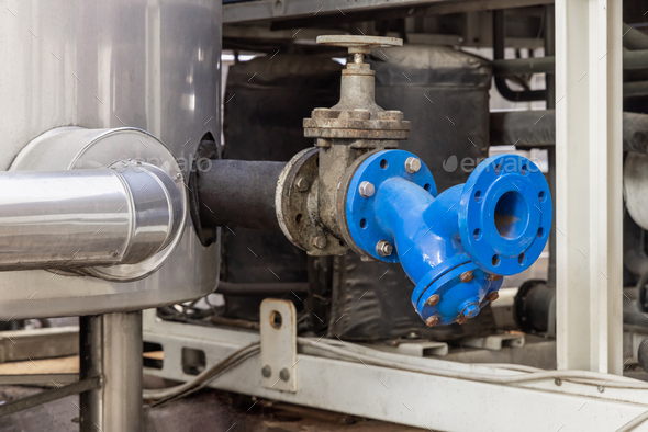 Handwheel type blue metal valve and pipes, industrial equipment at wine factory, close up - Stock Photo - Images