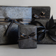 Wrapped Black Gift Boxes with a ribbon bow on grey close up - PhotoDune Item for Sale