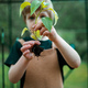 Little boy holding pepper plant, when transplanting it in eco greenhouse, learn gardening. - PhotoDune Item for Sale
