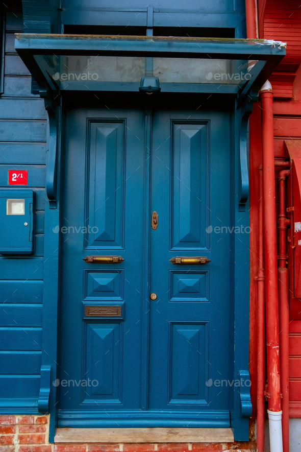 Large heavy wooden door  painted in blue in Kuzguncuk, Istabnbul. - Stock Photo - Images