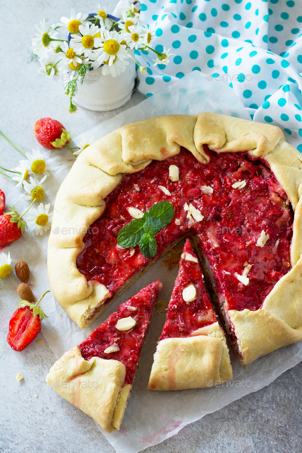 Fresh homemade strawberries galette with nut cream on a gray stone or slate background. Copy space. - Stock Photo - Images