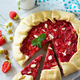 Fresh homemade strawberries galette with nut cream on a gray stone or slate background. Copy space. - PhotoDune Item for Sale