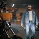 Portrait of bearded brutal biker looking motorcycle in garage workshop - PhotoDune Item for Sale