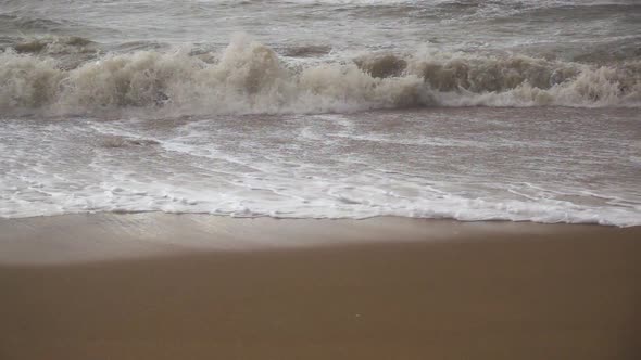  a Storm Wave Rolls Over a Sandy Beach