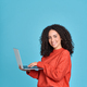 Young happy latin woman using laptop isolated on blue background. - PhotoDune Item for Sale