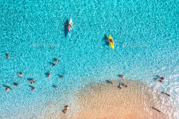 Aerial view of kayaks, swimming people in blue sea, sandy beach - Stock Photo - Images