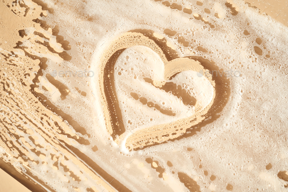 Photo of cosmetic foam or soap with a heart drawn on the foam. - Stock Photo - Images