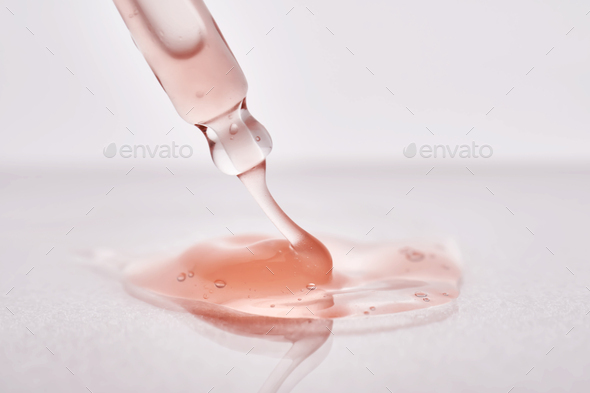 Pipette with a viscous pink cosmetic close-up. - Stock Photo - Images