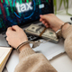a woman with handcuffs and a laptop pays taxes - PhotoDune Item for Sale