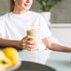 Young woman in white t-shirt and blue jeans drinking fruit smoothie healthy food in kitchen at home - PhotoDune Item for Sale
