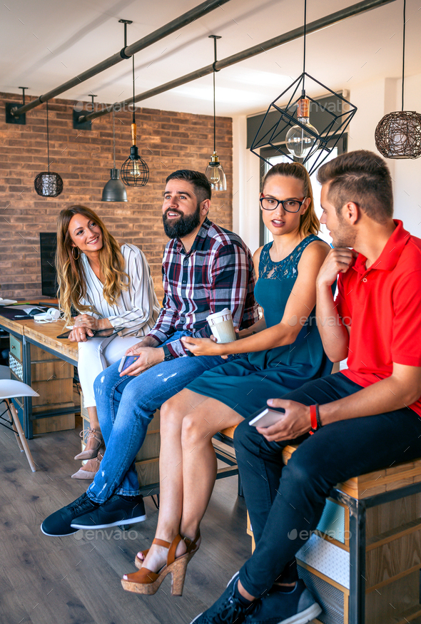Office workers team talking sitting over the table in coworking - Stock Photo - Images