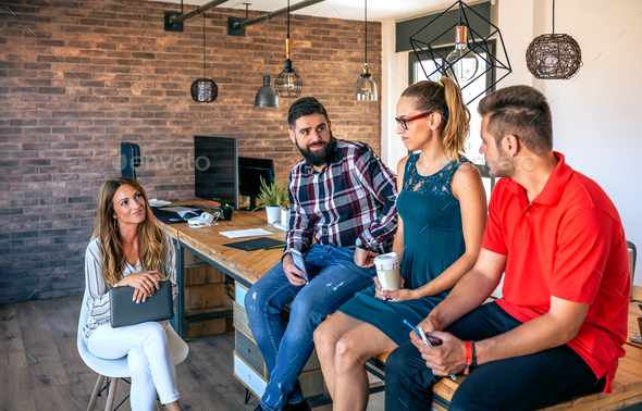 Office workers team talking sitting over the table in coworking - Stock Photo - Images