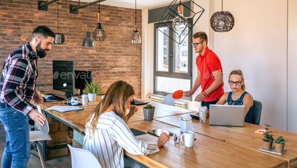Businessmen having fun playing with a basket ball in coworking office - Stock Photo - Images