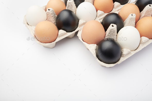 Eggs of different colors in cardboard boxes. Black, white and brown chicken eggs. - Stock Photo - Images