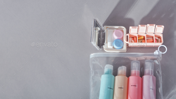 Travel kit. Set of plastic bottles for cosmetic products, kit for contact lenses, pill organizer. - Stock Photo - Images
