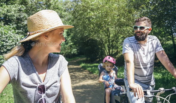 Couple talking while taking a family bike ride