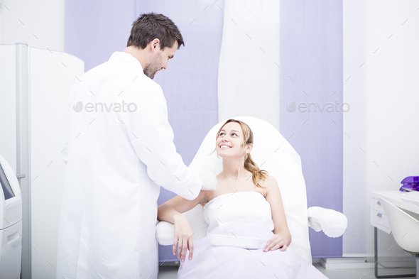 Aesthetic surgery, doctor talking to woman
