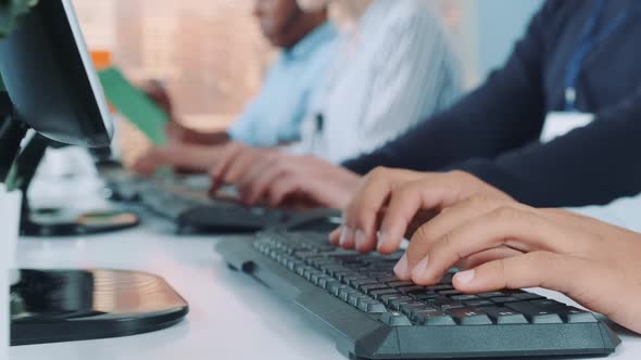 Close-up Shot of Operators Hands Typing on Keyboard in Modern Office