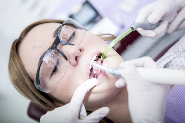 Woman at the dentist receiving root canal treatment