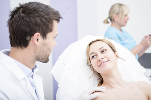 Aesthetic surgery, doctor talking to woman