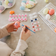 Young woman decorating Easter eggs using brush and paint on the kitchen. - PhotoDune Item for Sale
