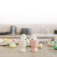 Holiday Easter preparations: handmade colored eggs, paints and brushes on a table. - PhotoDune Item for Sale