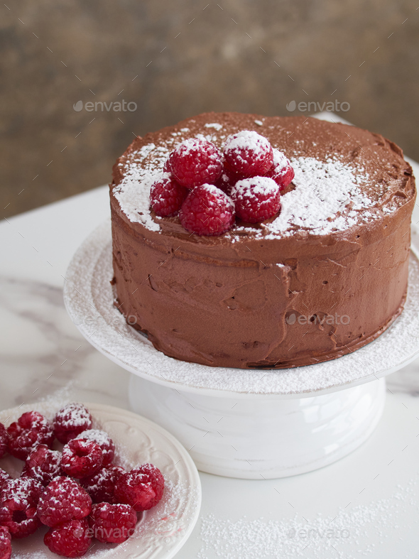 chocolate cake decorated with fresh raspberries and icing sugar ...