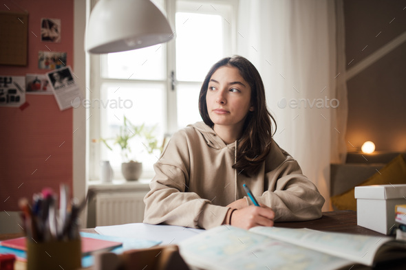 Young teenage girl studying in her room. - Stock Photo - Images