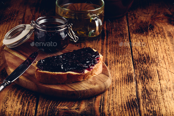 Toast with berry jam and green tea - Stock Photo - Images