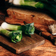 Fresh green leek on cutting board - PhotoDune Item for Sale