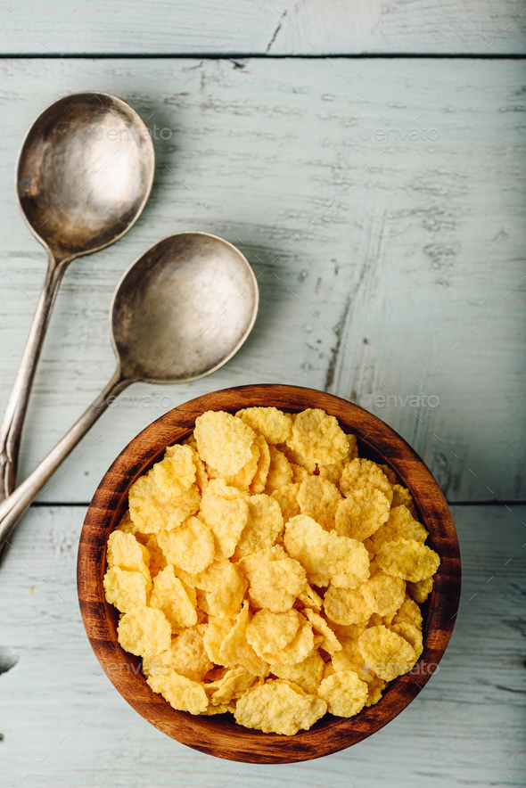 Rustic bowl of corn flakes with spoons - Stock Photo - Images