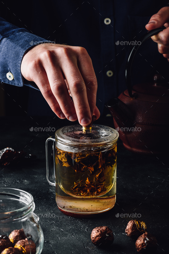 Steeping red tea in glass mug - Stock Photo - Images